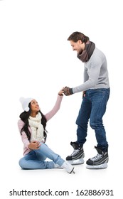 Careful Man Helping His Girlfriend To Stand Up After Falling On Skating Ring. Isolated On White 