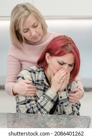 Careful Mother Hugs And Calms Her Crying Teen Daughter Home. Teenagers Problem Concept