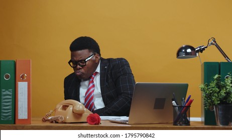 Careful Scared Black Head Businessman Counting His Money On Payday Hides Under Table Of Much Jealousy. Greedy Boss. Office Company. Comical Scene. Fun. Copy Space.