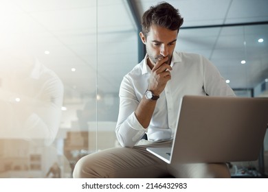 Carefully considering every option. Cropped shot of a handsome young businessman looking thoughtful while working on his laptop in the office. - Powered by Shutterstock