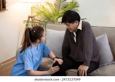 Caregiver Assisting Elderly Man with Physical Therapy at Home, Providing Support and Encouragement in a Comfortable Living Room Setting - Powered by Shutterstock