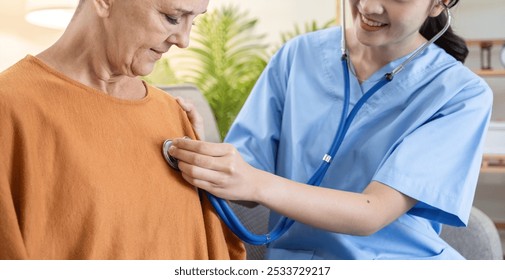Caregiver Assisting Elderly Woman with Health Checkup Using Stethoscope in Comfortable Home Environment