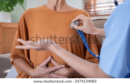 Caregiver Assisting Elderly Woman with Health Checkup at Home, Promoting Senior Wellness and Compassionate Care in a Comfortable Environment