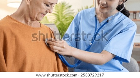 Caregiver Assisting Elderly Woman with Health Checkup Using Stethoscope in Comfortable Home Environment