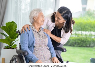 Caregiver Daughter Help Asian Senior Or Elderly Old Lady Woman Sitting On Wheelchair.