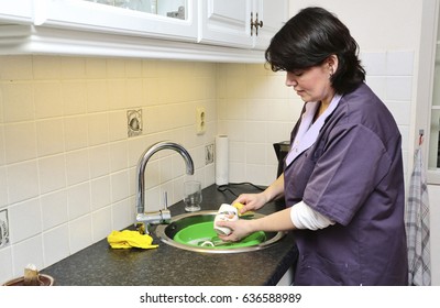 A Caregiver Is Doing The Dishes