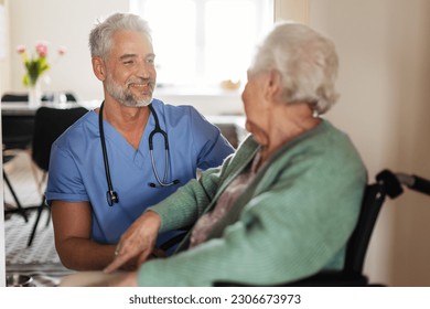 Caregiver doing regular check-up of senior woman in her home. - Powered by Shutterstock