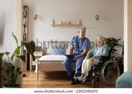 Caregiver doing regular check-up of senior woman in her home.