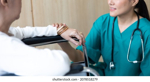 Caregiver And Elderly Home Care. Asian Woman Doctor Or Nurse Talking With Senior Patient.