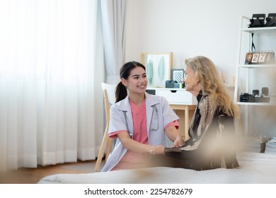 Caregiver for an elderly woman Weekly check-ups at the patient's residence. Ready to give medical advice and talk about various stories, exchange each other happily. - Shutterstock ID 2254782679