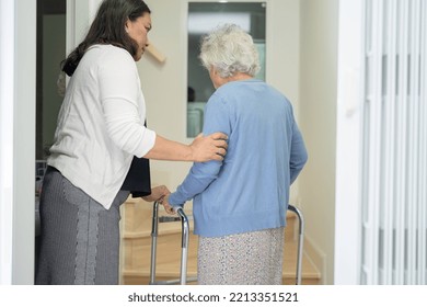 Caregiver help asian or elderly old woman walk with walker support up the stairs in home. - Powered by Shutterstock