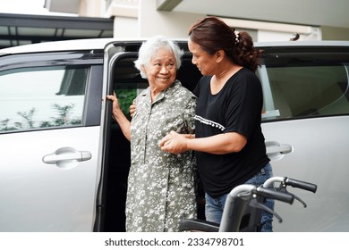 Caregiver help Asian elderly woman disability patient get in her car, medical concept. - Powered by Shutterstock