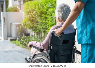 Caregiver Help And Care Asian Senior Or Elderly Old Lady Woman Patient Sitting In Wheelchair On Ramp At Nursing Hospital, Healthy Strong Medical Concept