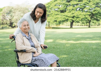 Caregiver Help And Care Asian Senior Or Elderly Old Lady Woman Patient Sitting On Wheelchair In Park, Healthy Strong Medical Concept.