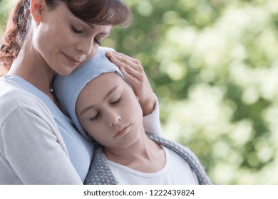 Caregiver Hugging Sick And Weak Kid With Cancer During Chemotherapy