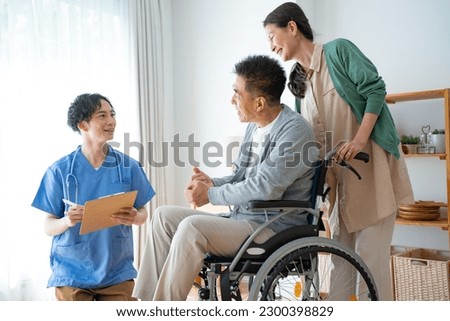 Caregiver and Japanese couple at home