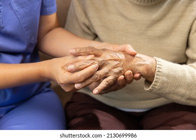 Caregiver Massaging Finger Of Elderly Woman In Painful Swollen Gout .