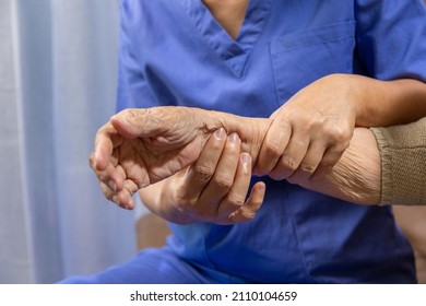 Caregiver Massaging Wrist Of Elderly Woman In Painful Swollen Gout .