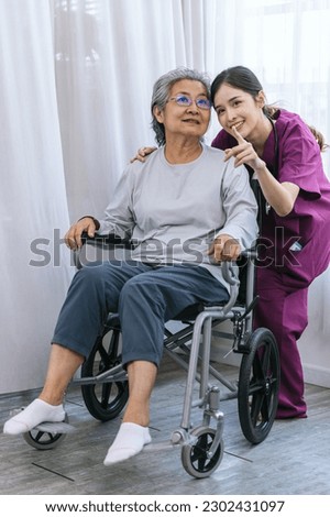 Similar – Doctor talking to elderly patient in a wheelchair