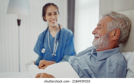 Caregiver nurse taking care senior man to bed in the room at hospital ward. - Powered by Shutterstock