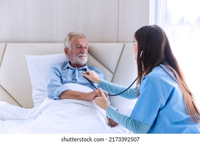 Caregiver Nurse Using Stethoscope Checking To Senior Patient. Nurse Helping Stethoscope Checking Patient For Listening Heart Rate At Home