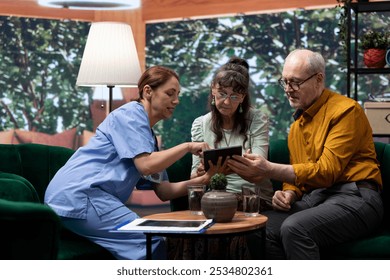 Caregiver providing health aid and medication to elderly couple during a home visit, showcasing senior living support and professional medical treatment. Personal care for recovery. - Powered by Shutterstock