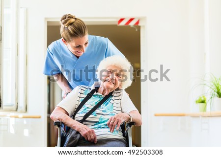 Similar – Doctor talking to elderly patient in a wheelchair