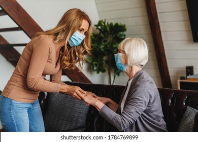 Caregiver Woman Or Daughter Take Care Of The Senior Woman In Protective Mask At Home