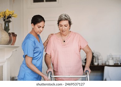 Caregiver, woman and helping with walker at nursing home for mobility support, physical therapy or hope for healing disability. Nurse, patient and physiotherapy for anatomy, balance or rehabilitation - Powered by Shutterstock