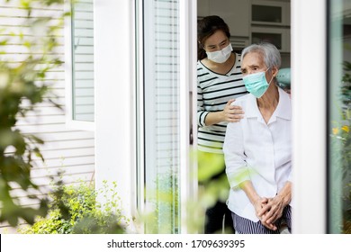 Caregiver Woman Take Care Of The Elderly,depressed Senior Is Waiting For Her Family To Visit At Home,social Distancing,nostalgia,stress,life Depression,stay Home During Covid-19,Coronavirus Pandemic  