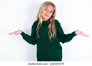 Careless Attractive Caucasian Teen Girl Wearing Green Knitted Sweater Over White Background Shrugging Shoulders, Oops.