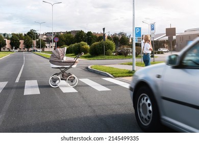 Careless mother speaking by phone while her baby pram rolled out on the road with a moving car.