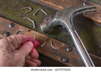Carelessly hammering on bent nails
Bending nails because you hit them without proper skills 