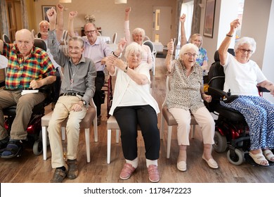 Carer Leading Group Of Seniors In Fitness Class In Retirement Home - Powered by Shutterstock