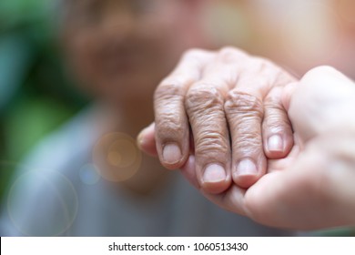 Caretaker, Carer Hand Holding Elder Hand Woman In Hospice Care. Philanthropy Kindness To Disabled Concept.