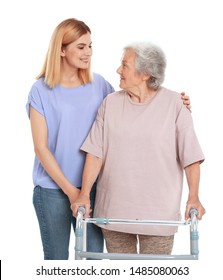Caretaker helping elderly woman with walking frame on white background