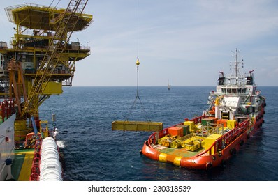 Cargo Being Loaded From A Offshore Platform Onto A Supply Vessel