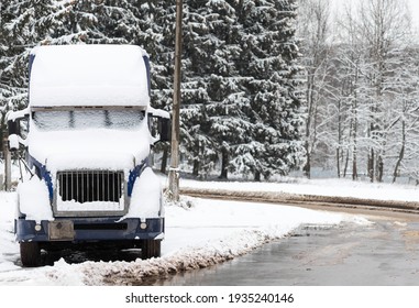 Cargo Blue Car In Winter Parked On The Side Of The Road. Truck Covered With Snow.