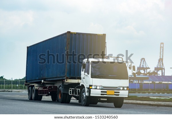 Cargo blue Container truck in ship port\
Logistics.Transportation industry in port business\
concept.import,export logistic industrial Transporting Land\
transport on Port transportation storge\
