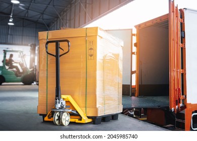 Cargo Box With Hand Pallet Truck  Is Loading Into A Container. Shipment Supply Chain Delivery. Warehouse Logistics. Cargo Freight Truck Transportation.	