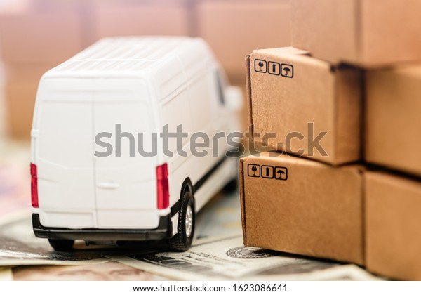Cargo bus and a\
lot of cardboard boxes on a money background. Cargo Delivery\
Business Development\
Concept.
