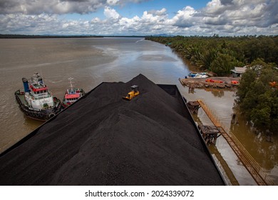
cargo of coal on barges as a distribution process which then goes to cargo ships at sea and is sent to overseas customers, North Kalimantan-Indonesia.May 8 2014