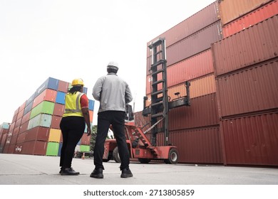 Cargo container and Import, export , Worker control reach stacker at container yard. Group of worker working and managing cargo container at container yard