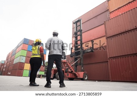 Cargo container and Import, export , Worker control reach stacker at container yard. Group of worker working and managing cargo container at container yard