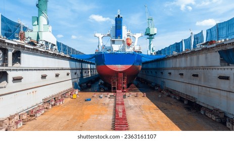 cargo container ship at dry dock concept maintenance service working in the sea. Insurance and Maintenance Cargo Ship concept. Freight Forwarding Service maintenance Insurance