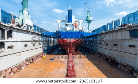cargo container ship at dry dock concept maintenance service working in the sea. Insurance and Maintenance Cargo Ship concept. Freight Forwarding Service maintenance Insurance