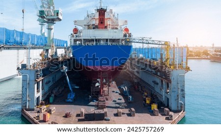 Cargo container ship at dry dock concept maintenance service. working at dry dock. Insurance and Maintenance Crude tanker Ship concept. Freight Forwarding Service maintenance Insurance.	