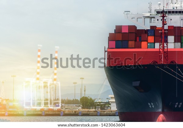 Cargo\
container ship mooring in port with Container stacking on board\
front ship view in port under bridge crane, view of commercial\
Logistic import export during berthed in\
port.
