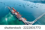 Cargo container Ship running to Bridge Cargo Shipyard Container ship under the crane Sea Port service logistics and transportation. International Shipping Depot Customs Port for import export trade. 