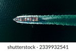 cargo container ship sailing full speed in sea to import export goods and distributing products to dealer and consumers worldwide, by container ship Transport business delivery service, aerial view 